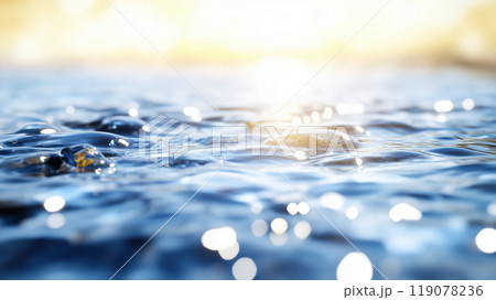 Glistening water surface with gentle ripples reflecting sunlight creates serene and tranquil atmosphere. interplay of light and water evokes sense of calm and peace 119078236