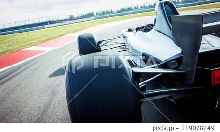 High performance racing car on racetrack, showcasing its sleek design and powerful rear tires. image captures essence of speed and precision in motorsport 119078249