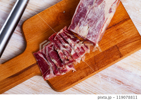 Sliced lacon curado on wooden background 119078811