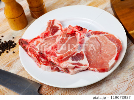 Fresh raw pork loin chops with condiments 119078987