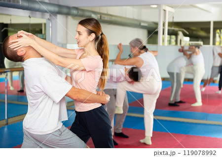 Self-defense course - woman strikes painful blow in the eyes of man Self-defense course - woman strikes painful blow in the eyes of man 119078992