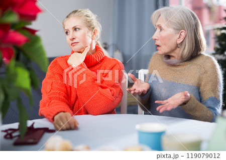 Home quarrel between mom and daughter during christmas closeup 119079012