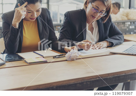 Asian businesswoman overworked at office stressful anxiety with serious problems. Woman exhaustion depress and mental burnout feeling tired frustrate at company office. Stress sadness contemplation 119079307