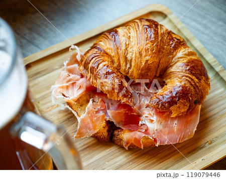 Croissant with ham served on platter Croissant with ham served on platter 119079446