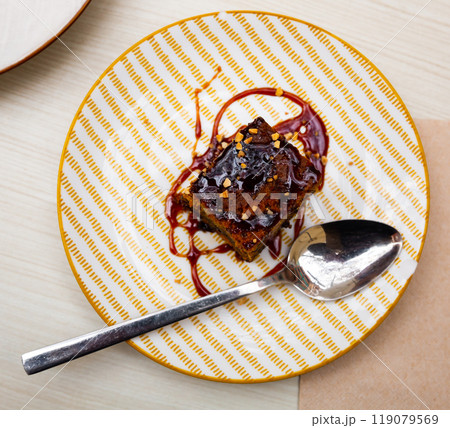 Traditional spanish dessert Tarta de zanahoria. Slice of carrot cake with chocolate syrup Traditional spanish dessert Tarta de zanahoria. Slice of carrot cake with chocolate syrup 119079569