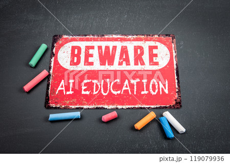 Ai education. Beware sign with text and colored pieces of chalk on a dark chalkboard background 119079936