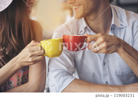 Young couple talking in cafe coffee shop happy date couple communication positive relationship while relaxing in cafe drinking coffee and talkative. Valentine's day concept. Young couple talking in cafe coffee shop happy date couple communication positive relationship while relaxing in cafe drinking coffee and talkative. Valentine's day concept. 119083231