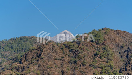 Tahtali Olympos mountain peak as seen from the Lycian Way in Cirali, Antalya, Turkey. The scenic landscape features lush forests, blue skies, and rugged slopes. Tahtali Olympos mountain peak as seen from the Lycian Way in Cirali, Antalya, Turkey. The scenic landscape features lush forests, blue skies, and rugged slopes. 119083750