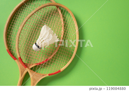 White badminton shuttlecock and two badminton rackets. Concept racket sport. 119084880