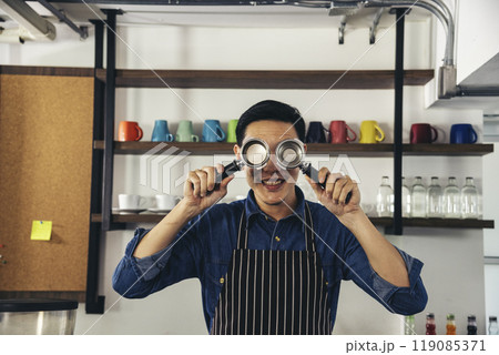 Portrait Barista small business Owner. Asian barista man coffee shop owner smiling look at camera small business confident person Entrepreneur manager professional men standing coffee counter bar Portrait Barista small business Owner. Asian barista man coffee shop owner smiling look at camera small business confident person Entrepreneur manager professional men standing coffee counter bar 119085371