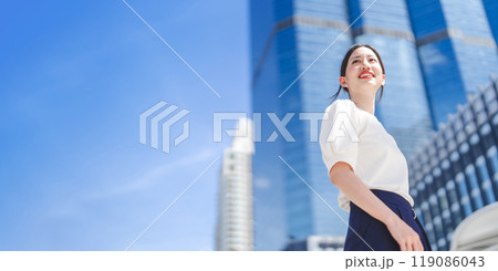 Portrait of successful business asian woman standing looking forward at outdoors in city 119086043