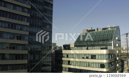 Top view of facade of beautiful glass skyscrapers. Stock footage. Beautiful glass skyscrapers in sunny summer day. Beautiful architecture of glass skyscrapers in center of modern city Top view of facade of beautiful glass skyscrapers. Stock footage. Beautiful glass skyscrapers in sunny summer day. Beautiful architecture of glass skyscrapers in center of modern city 119088569