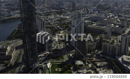 Top view of construction of building in city center with high-rise buildings. Stock footage. Landscape of city with high-rise buildings and building under construction in center. Beautiful summer Top view of construction of building in city center with high-rise buildings. Stock footage. Landscape of city with high-rise buildings and building under construction in center. Beautiful summer 119088889