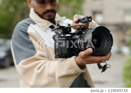 Operating Professional Camera during Outdoor Shoot Operating Professional Camera during Outdoor Shoot 119089738