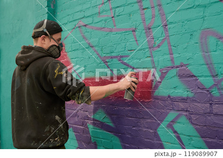 Guy applying purple paint from dispenser 119089907