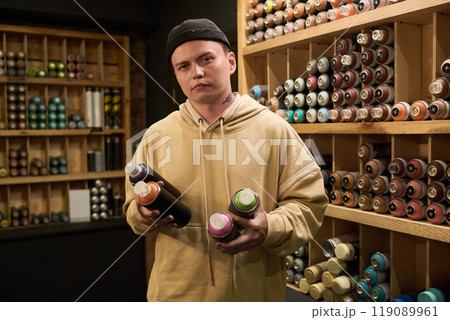 Young man with graffiti paints Young man with graffiti paints 119089961