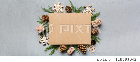 Flat lay Christmas composition. square Paper blank, pine tree branches, christmas decorations on Colored background. Top view, copy space for text 119093942