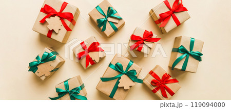 Colored craft gift boxes with colorful ribbons on colored background. Collection of Christmas present boxes Colored craft gift boxes with colorful ribbons on colored background. Collection of Christmas present boxes 119094000
