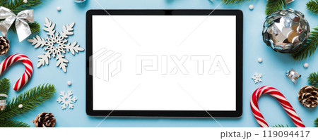 Top view of empty tablet on Christmas background made of new year decorand festive decorations. New year holiday concept. Mockup 119094417