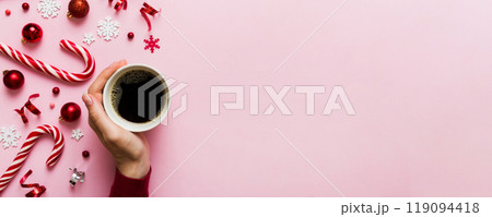 Woman holding cup of coffee. Woman hands holding a mug with hot coffee. Winter and Christmas time concept 119094418