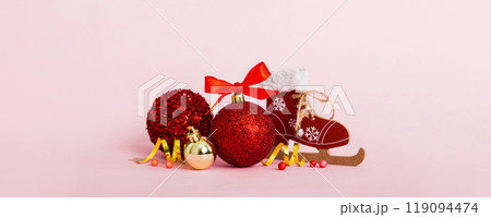 Christmas ball with skates on colored background. decoration bauble with ribbon bow with copy space Christmas ball with skates on colored background. decoration bauble with ribbon bow with copy space 119094474