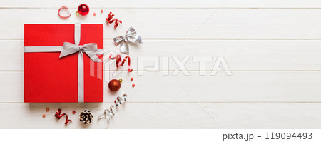 Top view Flat lay Christmas decorations and gift box on colored background with copy space. Christmas or Happy New Year composition 119094493