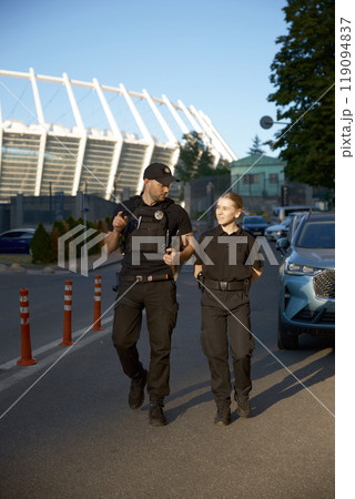 Friendly smiling patrol police officers outdoor Friendly smiling patrol police officers outdoor 119094837