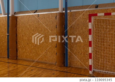 Indoor Handball Court with Goal Post and Wooden Walls in Gymnasium. Indoor Handball Court with Goal Post and Wooden Walls in Gymnasium. 119095345