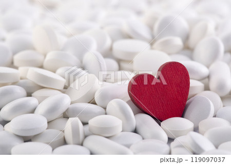 Red heart on heap of many various medicine pills 119097037