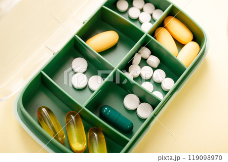 Pill box with various pills, vitamins and dietary supplement for every day, close-up. Pill box with various pills, vitamins and dietary supplement for every day, close-up. 119098970