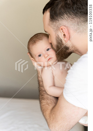 Bearded man young parent holding rocking child daughter or son in hands 119100338