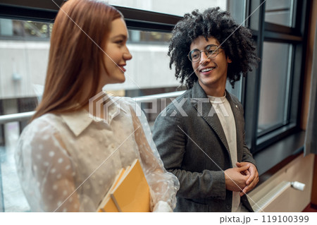 Young people talking, smiling and looking involved Young people talking, smiling and looking involved 119100399