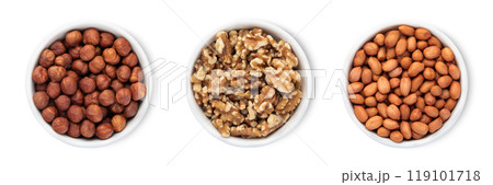 Bowl plates with hazelnut and walnut and peanut nuts isolated on white background.Top view. 119101718