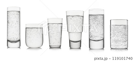 Sparkling mineral water with bubbles in various shape and size glasses on white background. 119101740