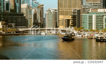View of the Dubai skyline at daytime, warm earth colors in beautiful contrast to the dark teal of the water. High quality photo 119102047