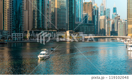 View of the Dubai skyline at daytime, warm earth colors in beautiful contrast to the dark teal of the water. High quality photo 119102048