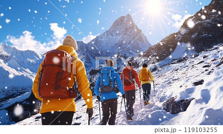 Group of Adventurers Hiking in Snowy Mountains on a Bright Sunny Day 119103255