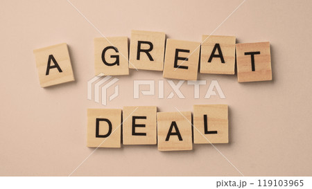 Word of A Great Deal. Text written by wood toy or wood cubes on white paper background 119103965