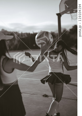 Energetic and Enthusiastic Cheerleaders Performing in Action with a Basketball on the Court Energetic and Enthusiastic Cheerleaders Performing in Action with a Basketball on the Court 119104194