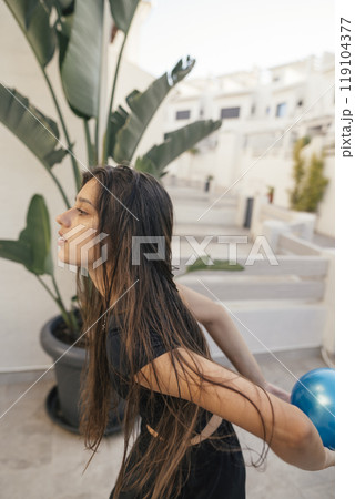 A creative portrait of a young woman captured beautifully in a vibrant tropical setting 119104377