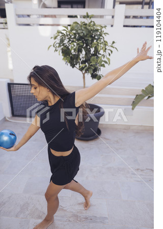 A dedicated fitness enthusiast is engaging in a vibrant and dynamic exercise routine 119104404
