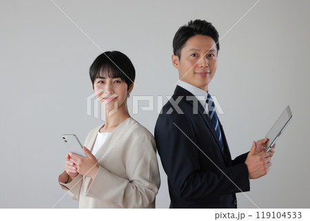 ビジネスパーソン男女_デバイスを持つ_背中合わせ_1 ビジネスパーソン男女_デバイスを持つ_背中合わせ_1 119104533