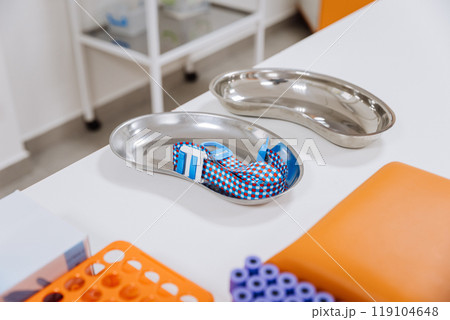 Medical instruments on table in clinical setting. Healthcare, laboratory, and hospital themes Medical instruments on table in clinical setting. Healthcare, laboratory, and hospital themes 119104648
