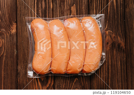 Vacuum-packed sausages on table, ideal for storage, transportation, or food photography purposes Vacuum-packed sausages on table, ideal for storage, transportation, or food photography purposes 119104650