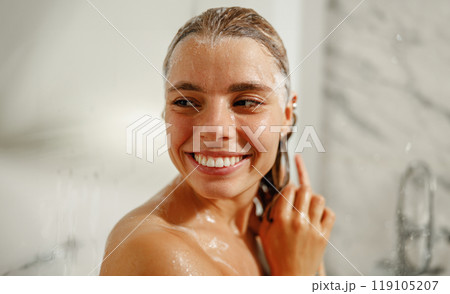Enjoying a Refreshing Shower Moment with a Joyful Young Woman Who Radiates Happiness Enjoying a Refreshing Shower Moment with a Joyful Young Woman Who Radiates Happiness 119105207