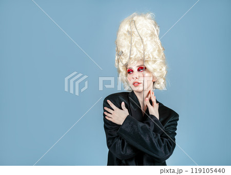 Thoughtful female model in blazer and huge wig 119105440