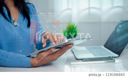 Businesswoman marking dates on virtual calendar with tablet, Managing his business schedule, Setting reminders for important appointments, creative collage for planning ideas, Appointment scheduler. Businesswoman marking dates on virtual calendar with tablet, Managing his business schedule, Setting reminders for important appointments, creative collage for planning ideas, Appointment scheduler. 119106883