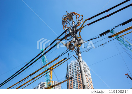 建設現場周辺の電線防護カバーと青空に伸びるクレーン　c-1 119108214