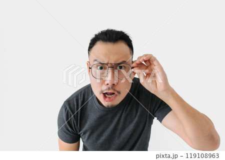 Serious angry face freelance man bun hair in black on white. Serious angry face freelance man bun hair in black on white. 119108963