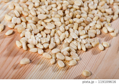 Picture of raw pine nut on the wooden desk, nobody 119109616